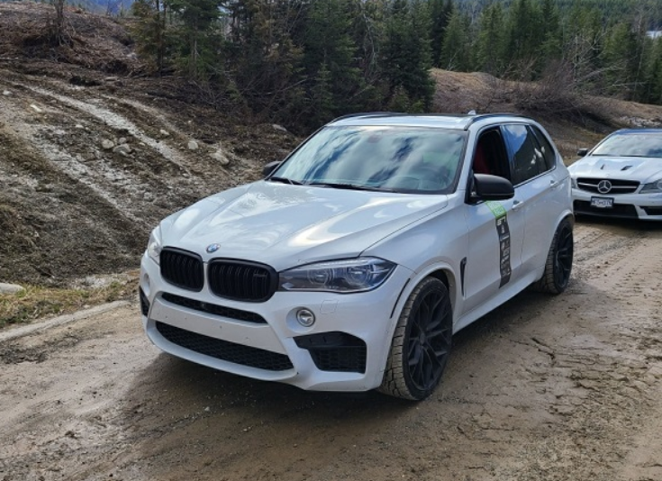 20 high-end rally cars stopped on Highway 1