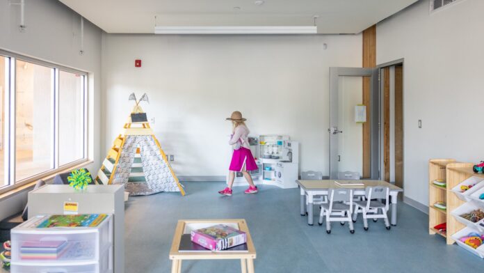 54748110627_d4309a8654_k Photo of a child walking through a new classroom.