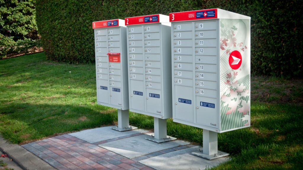 Three community mailboxes side by side in a residential neighbourhood